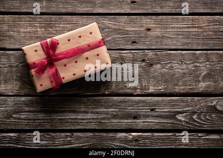 Gift box tied red ribbon with small hearts Stock Photo