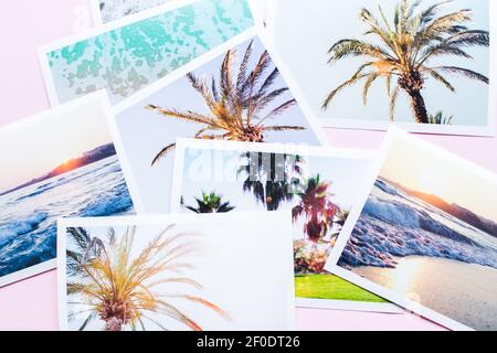 Stack of vacation holiday tropical printed pictures on pivk background. Happy memories concept. All photos belong to me. Top view. Stock Photo