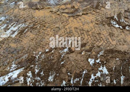 Heavy machinery tyre track impressions in mud on construction site Stock Photo