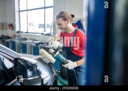 Man in uniform with special device near car Stock Photo