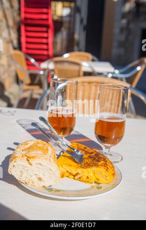Spanish omelet and two glasses of beer in a terrace. Spain. Stock Photo