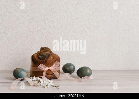 Easter cake and marble blue painted eggs, white flowers, festive composition, Russian Orthodox tradition, selective focus Stock Photo