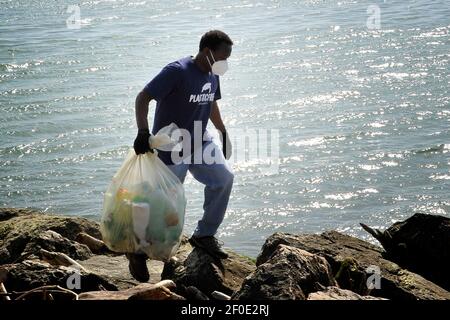 Volunteers of the Plastic Free association, clean up the 'Plastic Beach' of the right Volturno, so called for the enormous amount of accumulated waste Stock Photo