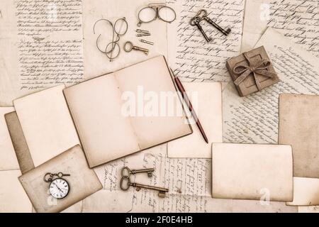 Open book and old handwritten letters. Vintage style flat lay background Stock Photo