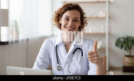 Portrait of smiling female doctor show thumb up Stock Photo