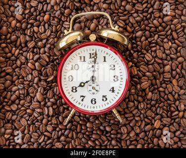 Vintage alarm clock on coffee beans Stock Photo