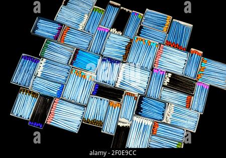 multicolored match sticks in boxes on a black background Stock Photo