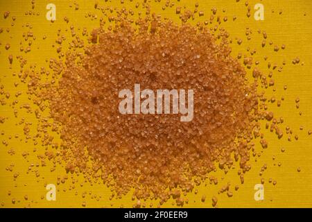 brown sugar cubes background on yellow colored paper sheet Stock Photo