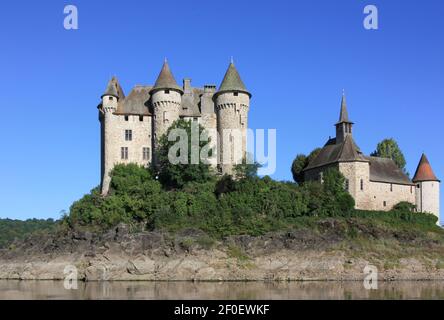 13th century Chateau de Val near Bort-les-Orgues, Lanobre, Cantal, Auvergne, France situated on an island after a dam was flooded for hydroelectricity Stock Photo