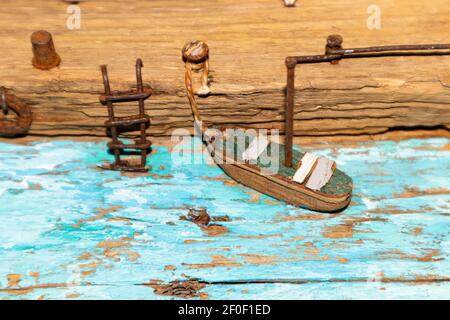 Colorful old miniature wooden houses stand on the embankment of the sea or river. Fishing nets. The boat is moored to the shore. The village of fisher Stock Photo