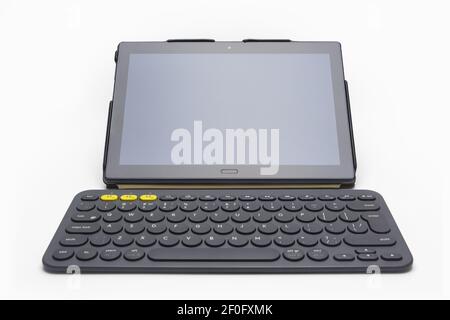 Tablet computer and small wireless keyboard on white background Stock Photo