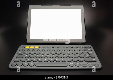 Tablet computer with white screen and small wireless keyboard Stock Photo