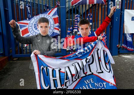 Rangers fans wearing Steven Gerrard masks hold up a banner outside of the Ibrox Stadium, home of Rangers FC. Picture date: Sunday March 7, 2021. Stock Photo