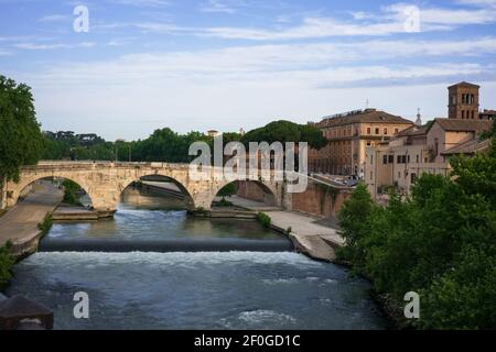 Ponte Cestio in stone with three arches, the Tiberina island, the bridle on the Tiber river Stock Photo