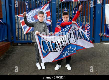 Rangers fans wearing Steven Gerrard masks hold up a banner outside of the Ibrox Stadium, home of Rangers FC. Picture date: Sunday March 7, 2021. Stock Photo