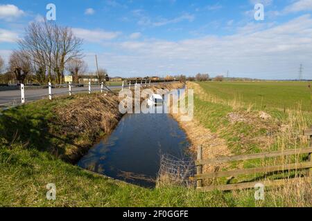 Rye, East Sussex, UK. 7th Mar, 2021. White Hyundai i10 car crashed through wooden fencing barrier and ends up half submerged in water ditch running parallel to A259 main road between Rye, East Sussex and Ashford, Kent. Photo Credit: Paul Lawrenson /Alamy Live News Stock Photo