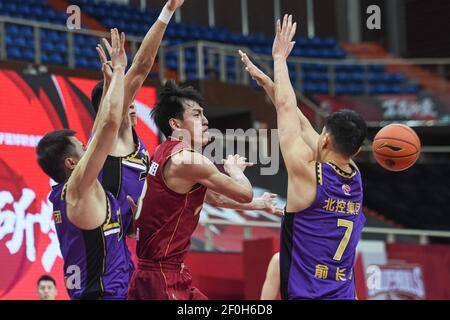 (210307) -- ZHUJI, March 7, 2021 (Xinhua) -- Wu Qian (2nd R) of Zhejiang Golden Bulls passes the ball during the 42nd round match between Zhejiang Golden Bulls and Beijing Royal Fighters at the 2020-2021 season of the Chinese Basketball Association (CBA) league in Zhuji, east China's Zhejiang Province, March 7, 2021. (Xinhua/Jiang Han) Stock Photo