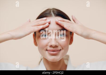 Young woman doing face building facial gymnastics self massage Stock Photo