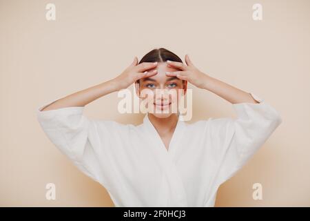 Young woman doing face building facial gymnastics self massage Stock Photo