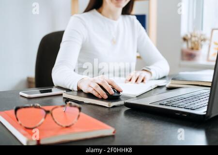 Remote Accounting Finance Jobs. Online Accounting Solution. Candid portrait of female accountant working with laptop, calculator and documents at home Stock Photo