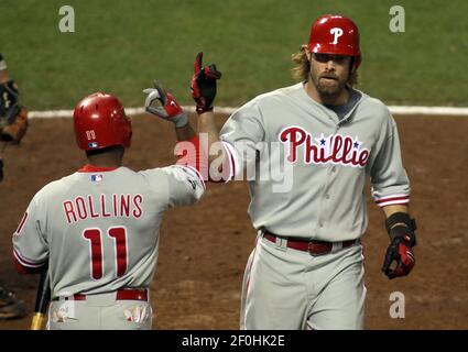 Philadelphia Phillies' Jayson Werth, right, is congratulated by teammate  Pat Burrell after Werth scored during the first inning of a baseball game  against the San Diego Padres Saturday, Aug. 16, 2008, in