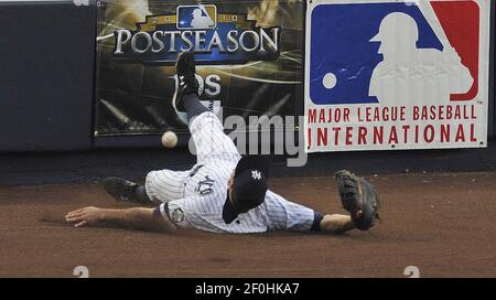 New York Yankees' Lance Berkman rips off his shirt during batting