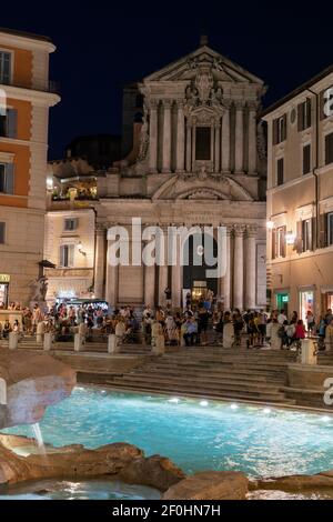 Italy, Rome, Santi Vincenzo e Anastasio a Fontana di Trevi (Saint Vincent and Anastasius at Trevi) and people at Piazza di Trevi by night Stock Photo