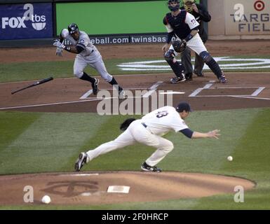 Minnesota Twins' J.J. Hardy hits a fly ball to left field in the sixth  inning of a baseball game against the Detroit Tigers Tuesday, April 27, 2010  in Detroit. Tigers' left fielder