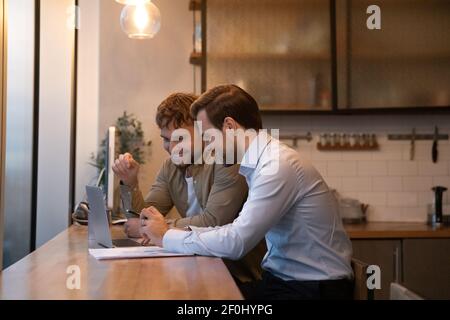 Side view happy colleagues working on online project together Stock Photo