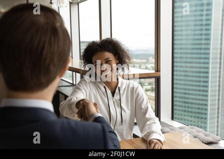 Smiling African American woman and hr manager shaking hands Stock Photo