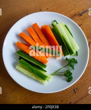 Crudites carrot and cucumber on white plate Stock Photo