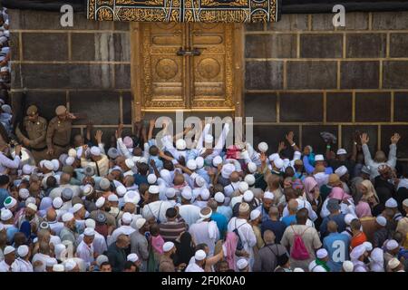 The door of the Kaaba - Multazam. Muslim pilgrims in motion in front of the door of the holy Kaaba. Stock Photo