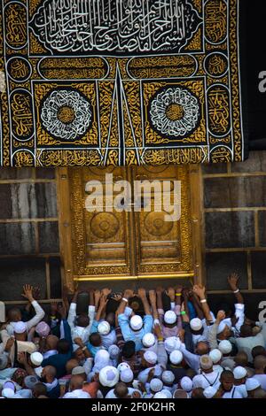 The door of the Kaaba - Multazam. Muslim pilgrims in motion in front of the door of the holy Kaaba. Stock Photo