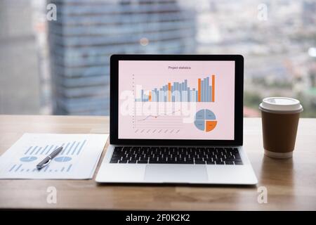 Close up office interior, workplace with laptop, financial documents Stock Photo