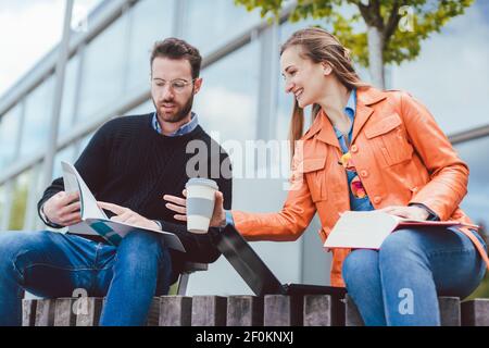 Woman and man studying together on university campus Stock Photo