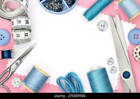 Pink template for sewing product with white background and set of seamstress tools, scissors, tape measure, button and spool of threads