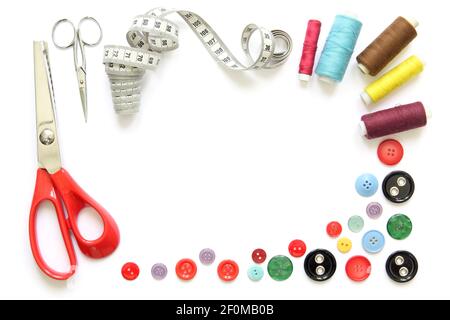 Kit design of sewing tools isolated on white background: spools of thread, needle, a pair of button scissors and a tape measure Stock Photo