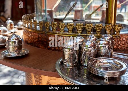 Traditional pots and Turkish coffee cups at a street's cafe in the downtown of Istanbul city, Turkey Stock Photo