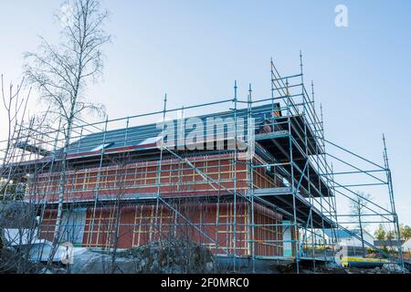 Close up view building under construction on blue sky background. Industry concept. Sweden. Stock Photo