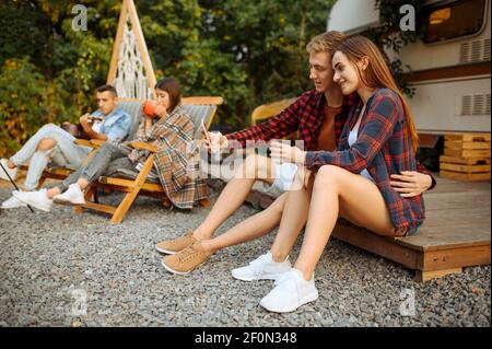 Happy friends makes selfie on picnic at camping Stock Photo