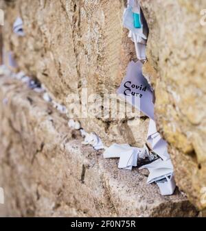 Covid cure message on notes to God in the cracks between the bricks of the Western Wall, Israel Stock Photo