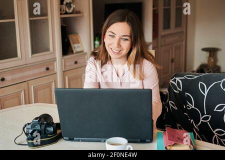 Young woman works from home on her laptop Stock Photo