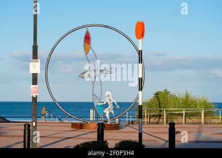 Orewa New Zealand - February 19 2021; Circular modern coastal sculpture with bird on path along beach Stock Photo