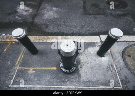 Wet fire hydrant in the street of New York City, selective focus, USA. Stock Photo