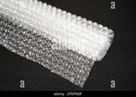bubble wrap roll on a dark background Stock Photo
