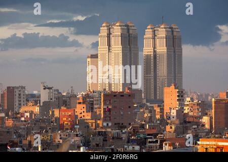 Cityscape view showing the Fairmont Nile City Hotel at sunset, as seen from the roof terrace of the Odeon Palace Bar, Qasr El Nil, Cairo, Egypt Stock Photo