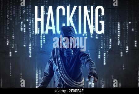 Faceless hacker with HACKING inscription, hacking concept Stock Photo