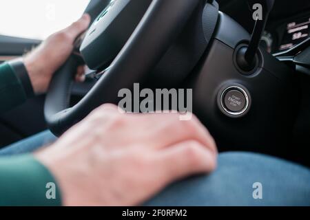 Close up mans hands on the wheel, driving a car.  Stock Photo