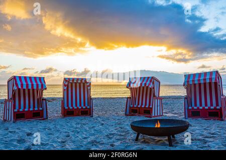 Beach chairs and fire bowl at sunrise at the big beach of Thiessow, island Ruegen, Baltic Sea, Mecklenburg-Western Pomerania, East Germany Stock Photo