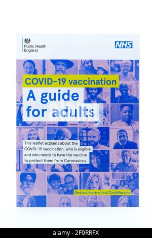 A UK NHS Covid 19 Vaccination guide for adults leaflet. The guide is provided with letters posted to people inviting them to book their vaccination Stock Photo